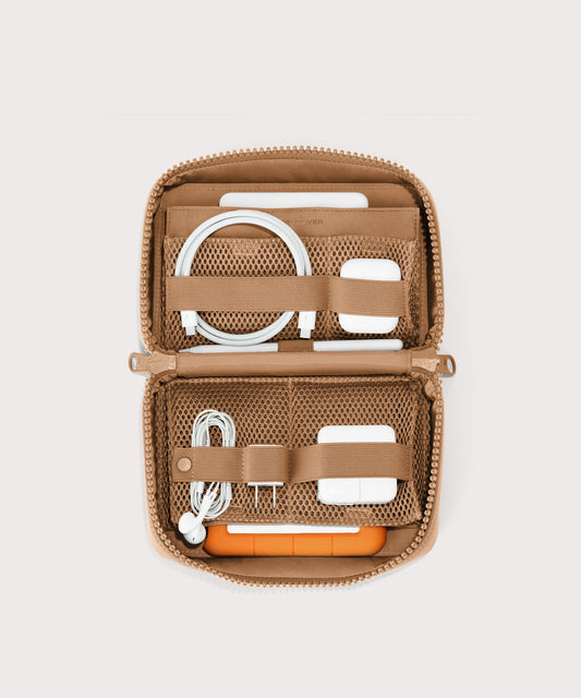 hover - Dagne Dover large Arlo Tech Organizer in camel unzipped, revealing the interior elastic loops and airmesh pockets.